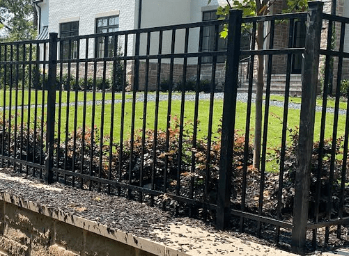 Aluminum Fence Installed Behind Retaining Wall in Atlanta aluminum fence installed behind a retaining wall for added security on an Atlanta property