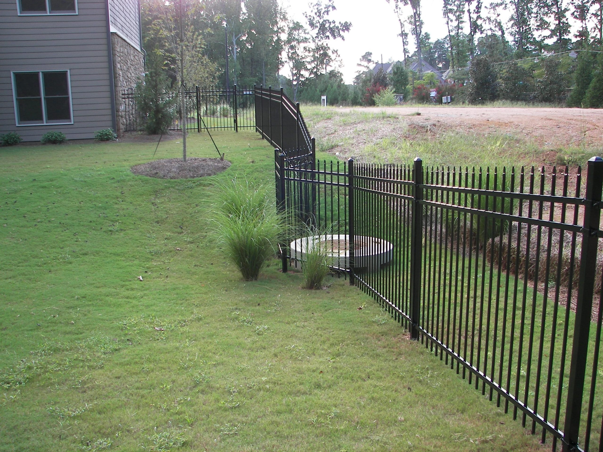 Black Aluminum Fence Installation with Grade Changes in Atlanta Yard