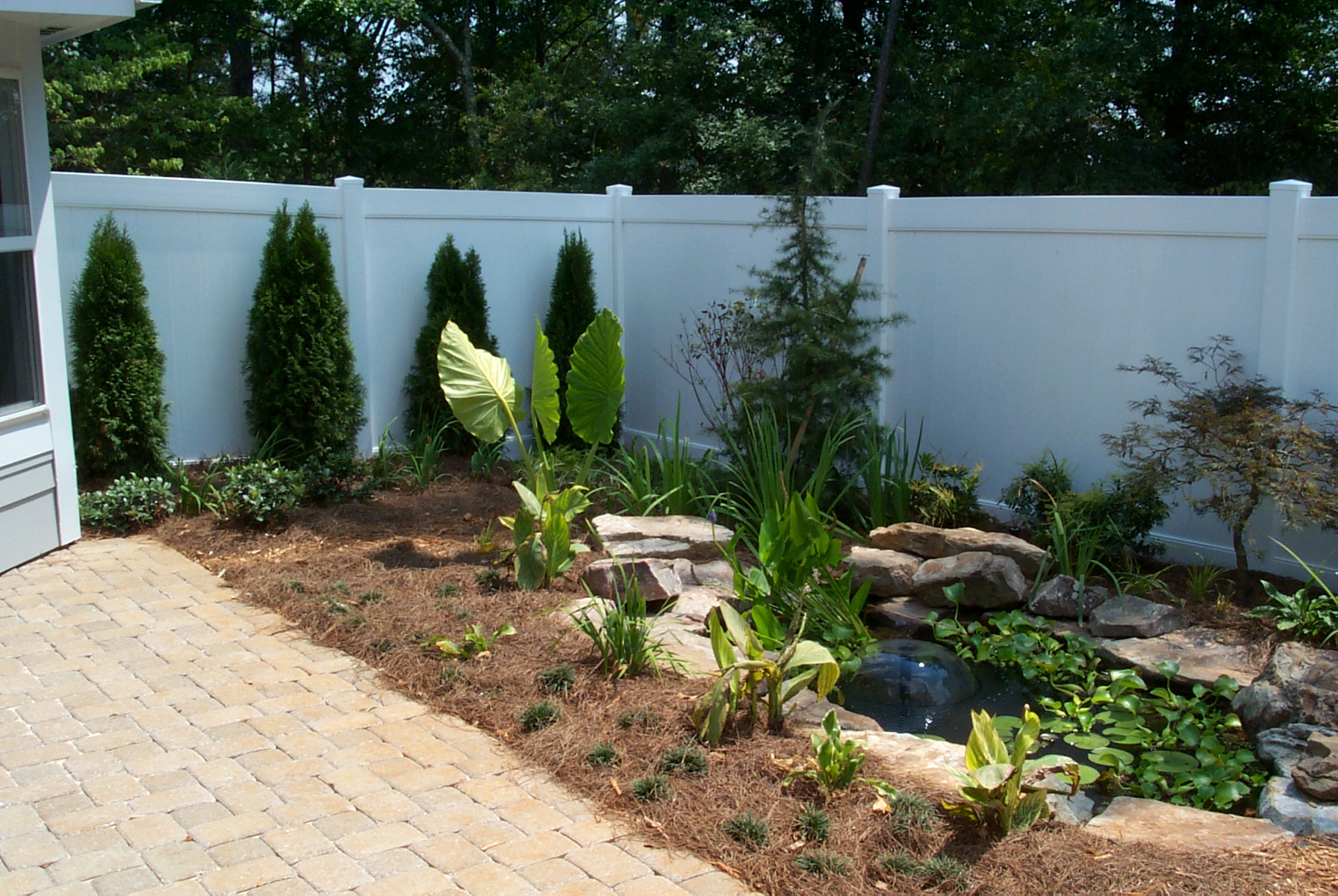 White vinyl privacy fence installed in a residential backyard by Summit Fence in Atlanta GA white vinyl fence installed in Marietta